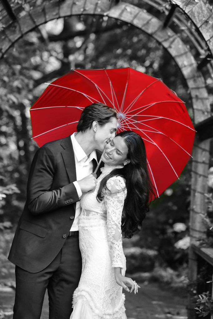 Engagement portrait with red umbrella
